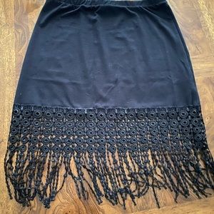 Never worn black mini skirt with black fringes. Slides on with no zippers.